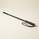 Black dressage whip with braided shaft and leather grip