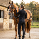 Winter thermal riding tights worn by rider at stable