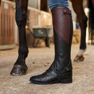 Rider wearing a leather half chap over a boot close-up